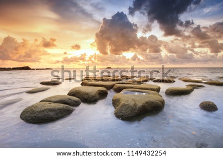 long expose seascape with beautiful rocks formation on foreground. soft focus due to long expose.