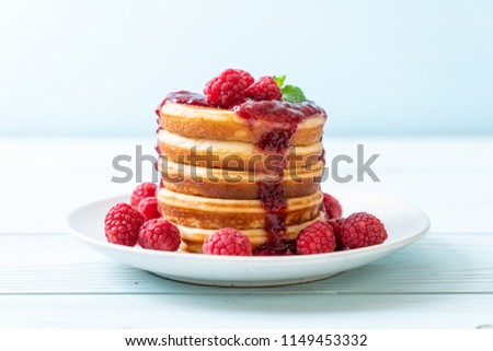 pancake with fresh raspberries and raspberry sauce Royalty-Free Stock Photo #1149453332