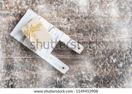 Old wooden toy sled with gift boxes on  wooden background. Top View Flat Lay Group Objects