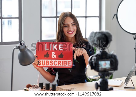 Female vlogger asking online audience to like and subscribe to her channel, daily videos Royalty-Free Stock Photo #1149517082