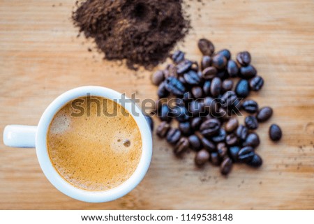 Cup of coffee, powder coffee and scoop on rusty background
