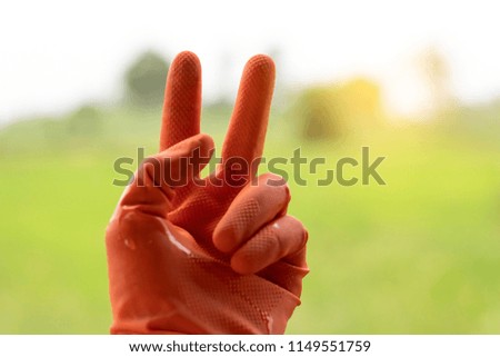 Two finger of famer on nature background.