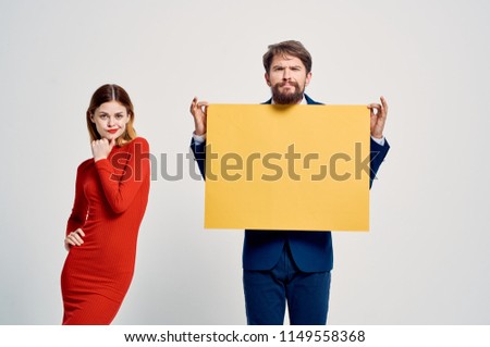  Stylish man and woman with a poster in hand.                              