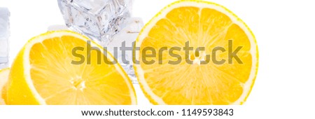 Cubes of cold ice, and halves of fresh, bright juicy lemon on a white background.