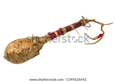 Indian rattle or drum mallets made of rawhide / leather wrapped in red fabric, isolated on white