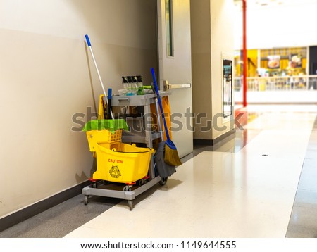 Cleaning tools cart wait for maid or cleaner in the department store. Bucket and set of cleaning equipment in the mall. Concept of service, worker and equipment for cleaner and health