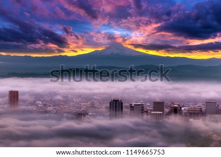 Dramatic colorful sunrise over Mount Hood and foggy Portland Oregon city downtown