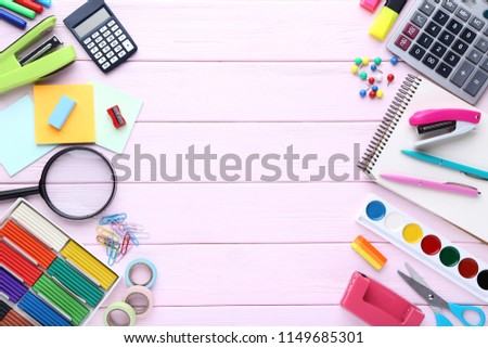 School supplies on pink wooden table