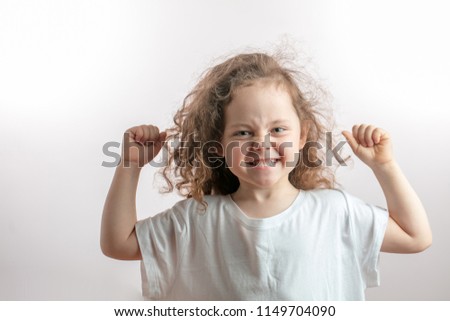 angry girl with long red wavy hair shoeing her strength. funny girl with raised arms demonstrating her biceps. bodybuilding, sport concept
