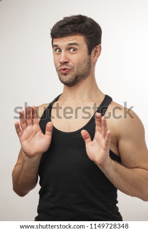 sporty man showing calming down sign. fear concept. please. take it easy.keep cool.