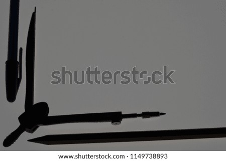 Silhouette of pen, divider, pencil for new education year. Elegant and creative photo for banner design or any other cool product which should stand out the crowd. Use it as frame.