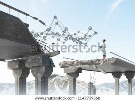 Young and professional woman doctor in white medical suit studying network structure while standing on broken bridge. Medical industry concept. Doctor using tablet