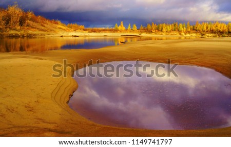 The golden autumn of the forest-tundra, the river against the ba