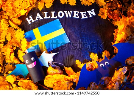 Holiday Halloween. Sweden. Autumn holiday. Vampires against the background of yellow leaves. Decoration for the holiday of Halloween in Sweden. the flag of Sweden.