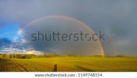  double rainbow in the evening sky over a field in Germany, Panorama