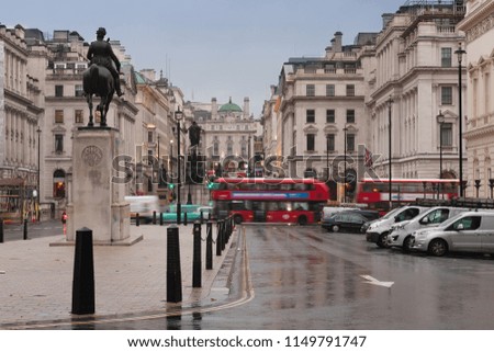 Public transport in Waterloo place in rainy early morning in London, United Kingdom