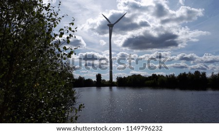 Windmill overlooking water.