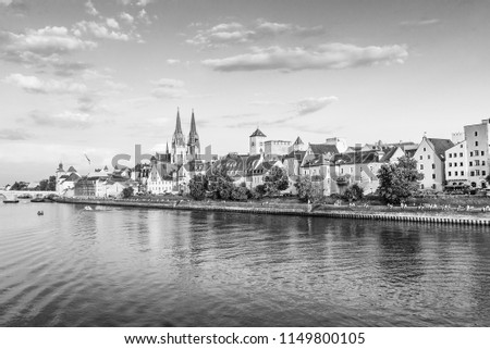 Regensburg city, Germany. View from Danube river, Regensburg Cathedral and Stone Bridge on background. Monochrome effect