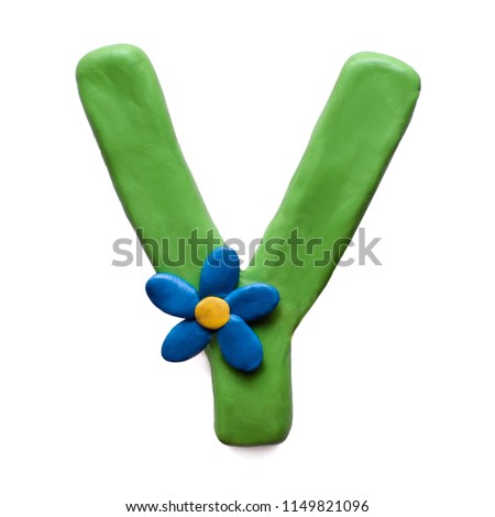 Green plasticine letter Y of English alphabet with blue flower, isolate on white background