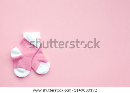 pair of small baby socks on pink background with copy space for your warm message Royalty-Free Stock Photo #1149839192