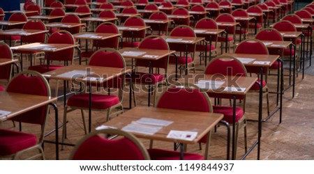 Hall with empty desks and tables, ready to be used for examination purposes. Royalty-Free Stock Photo #1149844937