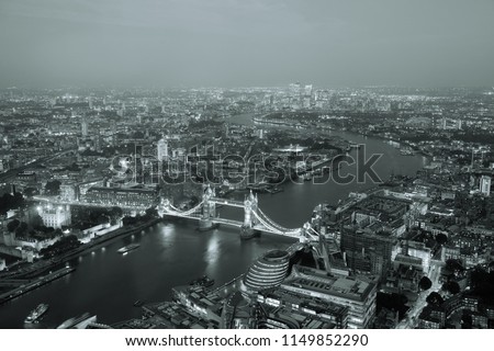 London aerial view panorama at night with urban architectures and Tower Bridge in BW.