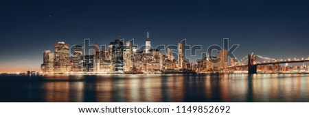 Downtown Manhattan skyline over East River at night in New York City