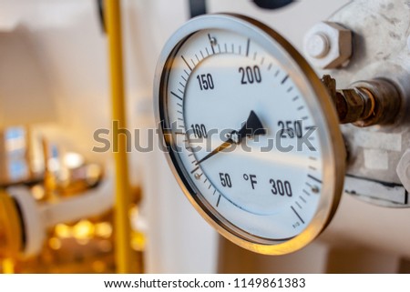 Thermometer, Temperature gauge or temperature indicator reading seventy five Fahrenheit (°F) in offshore oil and gas refinery process operation industry. Royalty-Free Stock Photo #1149861383