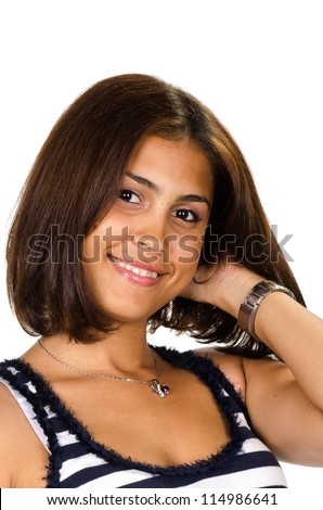 Portrait of young woman with hand on neck smiling at camera against white background