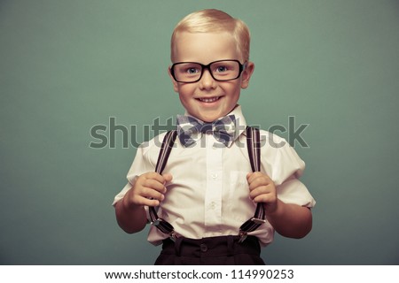 Cheerful smiling boy on a green background.