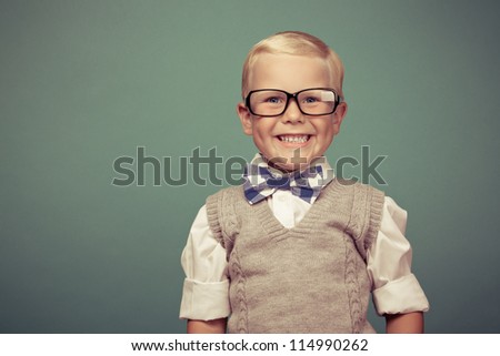 Cheerful smiling boy on a green background.