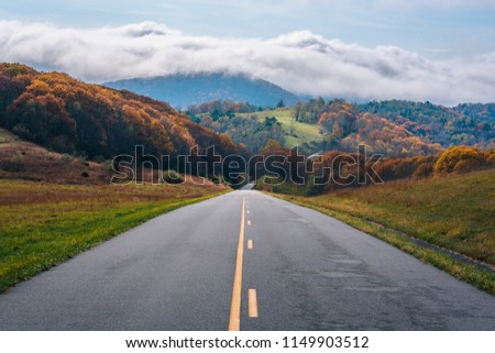The Blue Ridge Parkway and fog over mountains in Virginia. Royalty-Free Stock Photo #1149903512