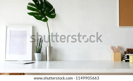 Working space and copy space.mockup poster on white desk
