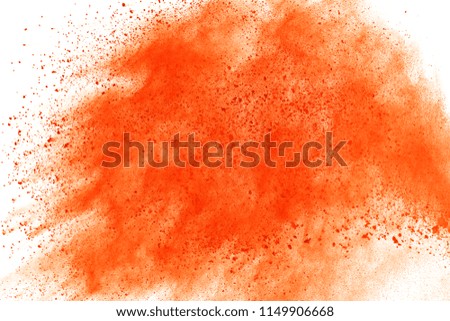 Explosion of colored powder isolated on white background. Power or clouds splatted. Freez motion of orange dust exploding.