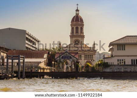 Beautiful crimson dome of Santa Cruz Church towers beside the Chao Phraya River. Santa Cruz Church also known as Kudi Chin, one of the many old Catholic churches in Bangkok, was built in 1770. Royalty-Free Stock Photo #1149922184