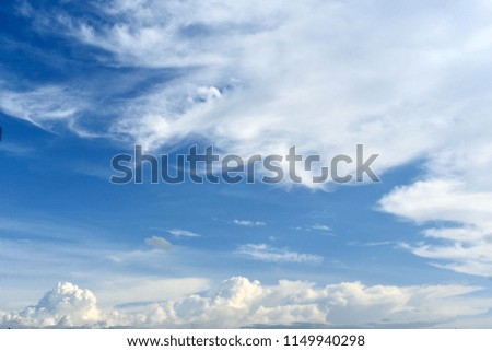 tropical cross white clouds in blue sky as background
