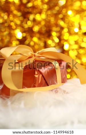  christmas golden gift on a furry background