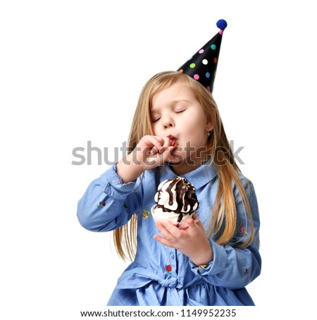 Three years girl kid eat tasty sweet chocolate cake celebrating in birthday cap isolated on a white background
