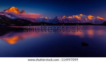 Sunset reflection in a lake in the Mont Blanc Mountains Royalty-Free Stock Photo #114997099