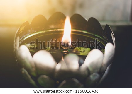 A row of oil lamp lighting in Thai Temple