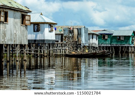 Poor Houses of locals in the Lake Village Ganvie, Benin, Africa Royalty-Free Stock Photo #1150021784
