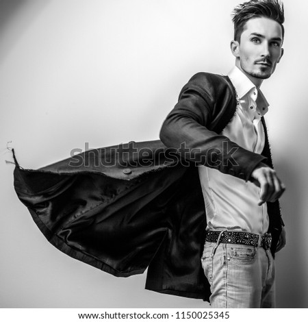 Elegant young handsome man. Black-white studio photo.