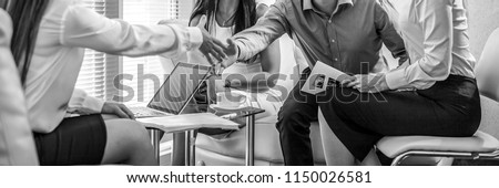 Group of business people at work black-white photo. Employers hands close-up. Royalty-Free Stock Photo #1150026581