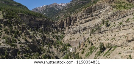 Panoramic view from drone of deep river gorge in the mountains of the American West.