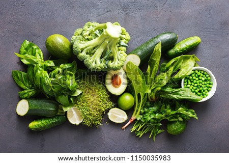 Set raw healthy food clean eating vegetables source of protein for vegetarians: cucumber, lucerne, zucchini, spinach, basil, green peas, avocado, broccoli, lime on black background, top view Royalty-Free Stock Photo #1150035983