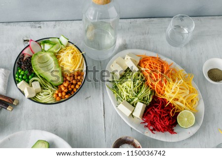 Healthy food clean eating. Spiralized vegetables with bowl of buddha on white wooden table top view