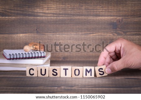 customs. wooden letters on the office desk, informative and communication background