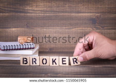broker. wooden letters on the office desk, informative and communication background