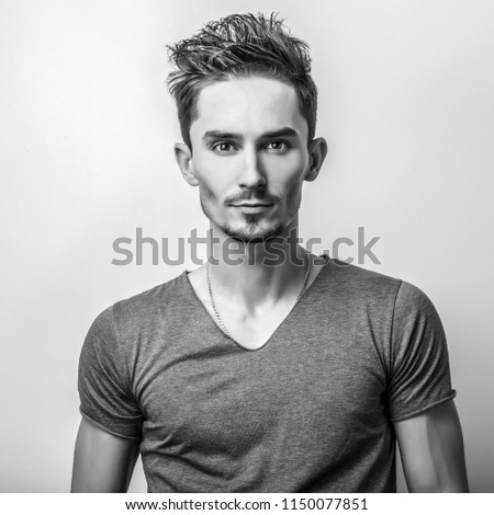Elegant young handsome man. Black-white studio photo.