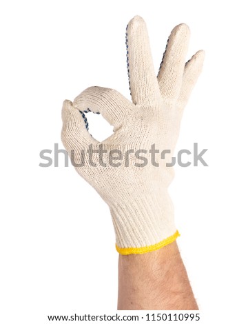 Worker showing gesture - ok sign. Male hand wearing working cotton glove with blue rubber dots, isolated on white background.